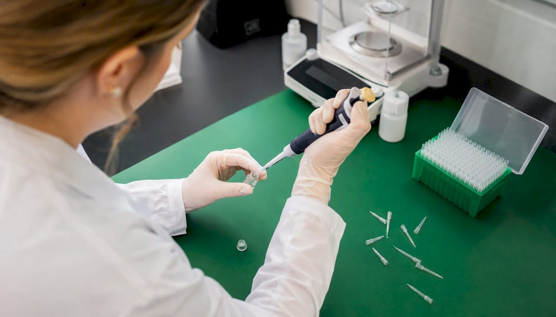 Hands pipetting peptide agonist solution in lab