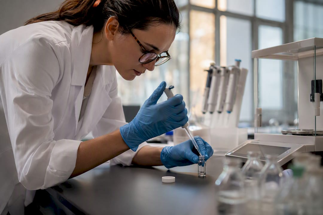 Lab hands reconstituting GLP-1 peptide vial